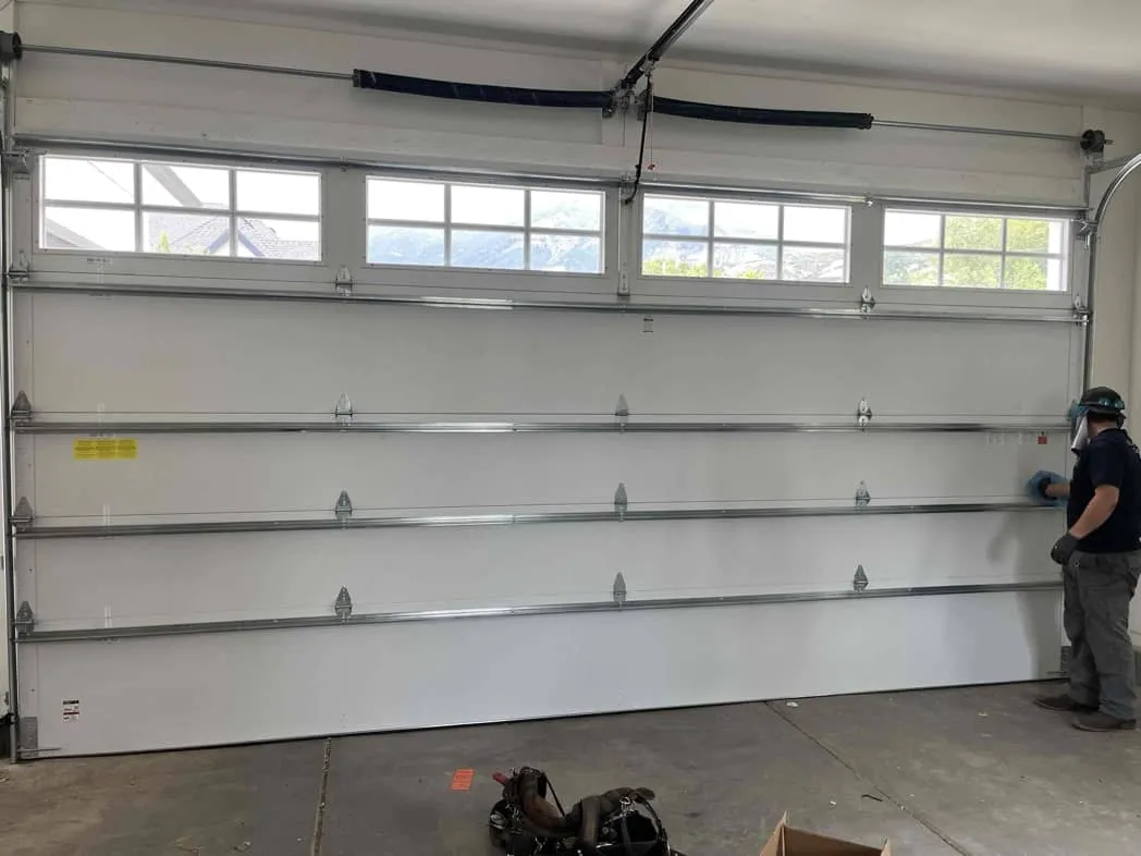 Technician finishing new garage door installation