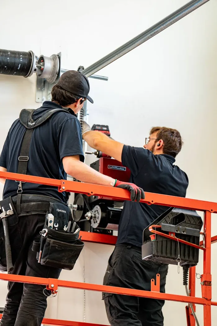 Team working on commercial LiftMaster garage door system