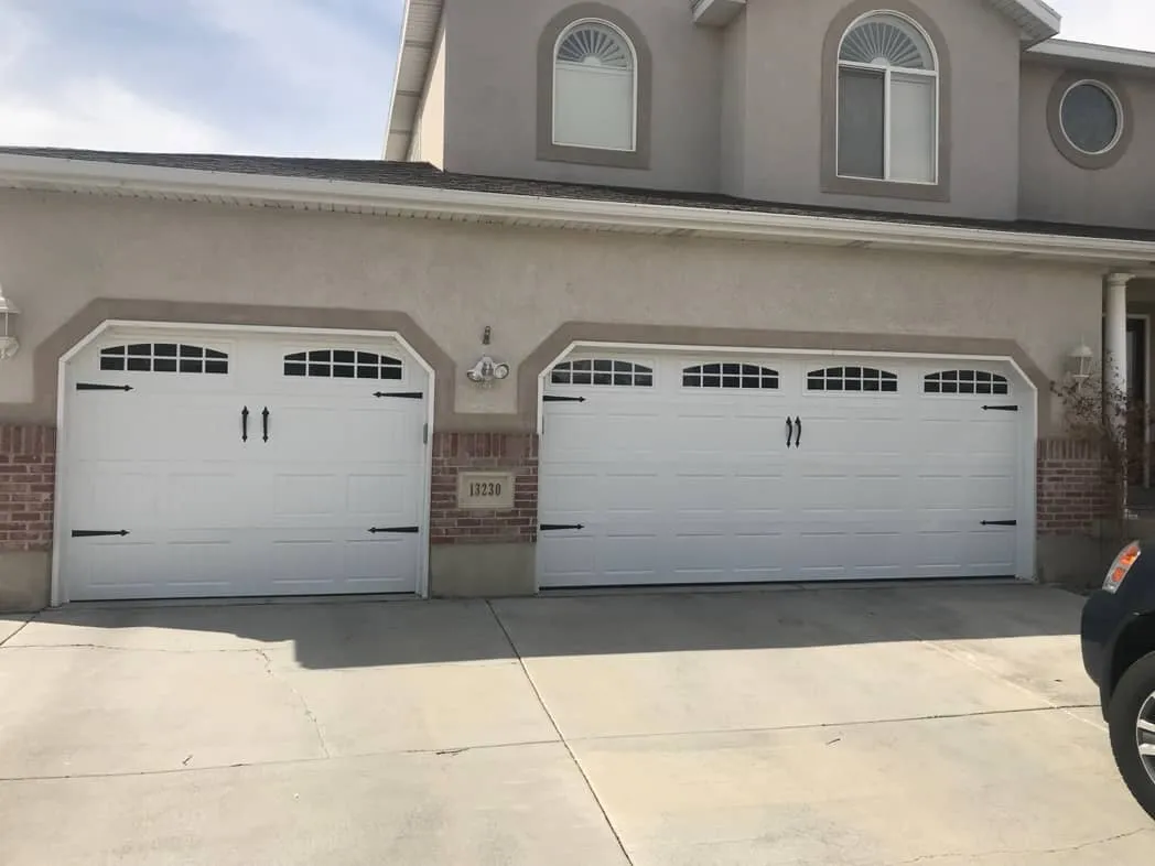 newly installed white residential garage doors with windows
