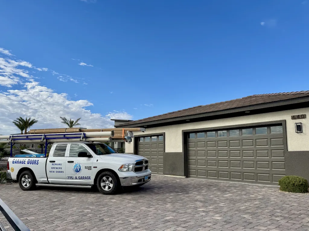A Plus Garage Doors service truck at a residential property