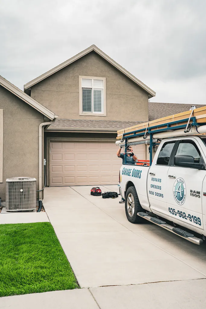 A Plus Garage Door Repair service truck in a residential driveway in Southern Utah