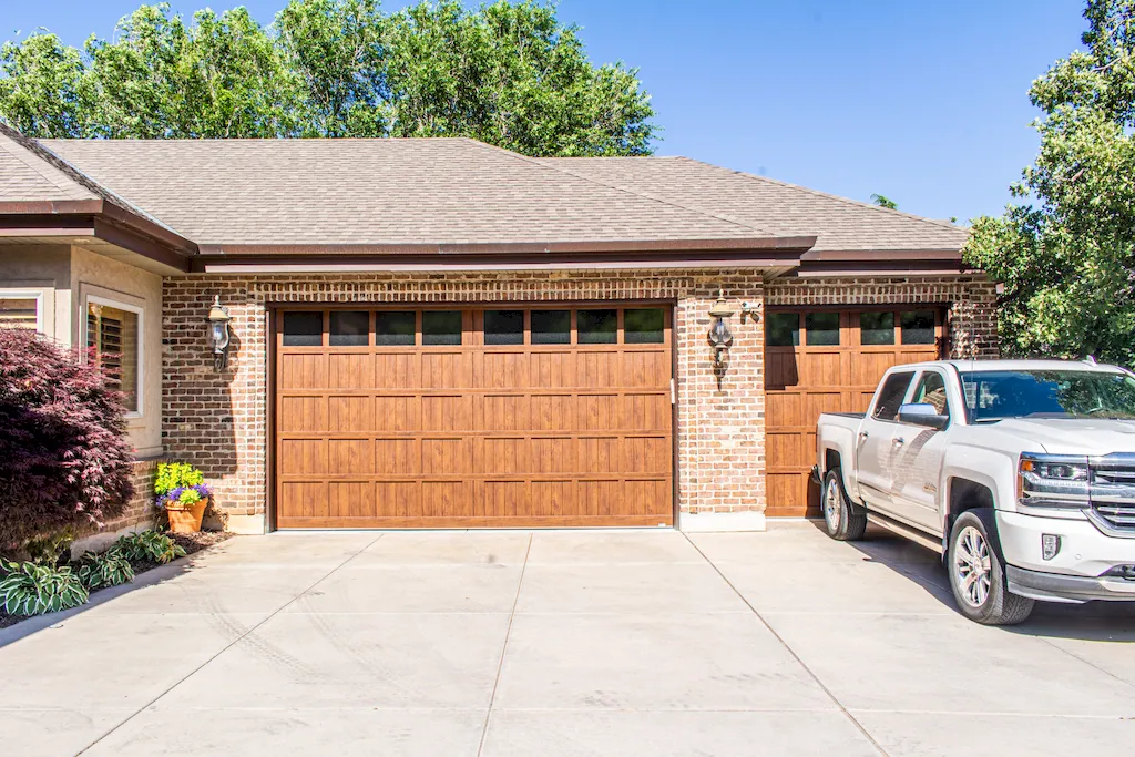 A Plus Garage Doors service vehicle at a residential garage