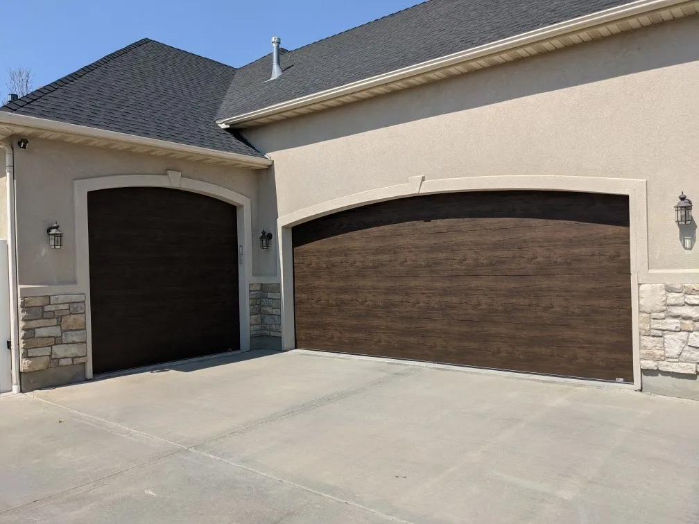 Black framed glass garage doors on a modern home