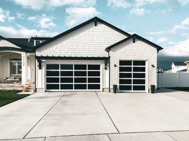 White House with Tinted Glass Garage Doors - Single & Double | Are Glass Garage Doors Insulated | Glass Garage Door Prices | A Plus Garage Doors