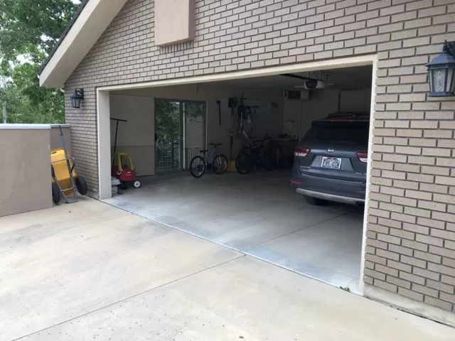 Gray Kia Car Parked in Garage | Does Keeping your Car in a Garage Make it Last Longer | Parking the Car in the Garage | A Plus Garage Doors Repairs & Services