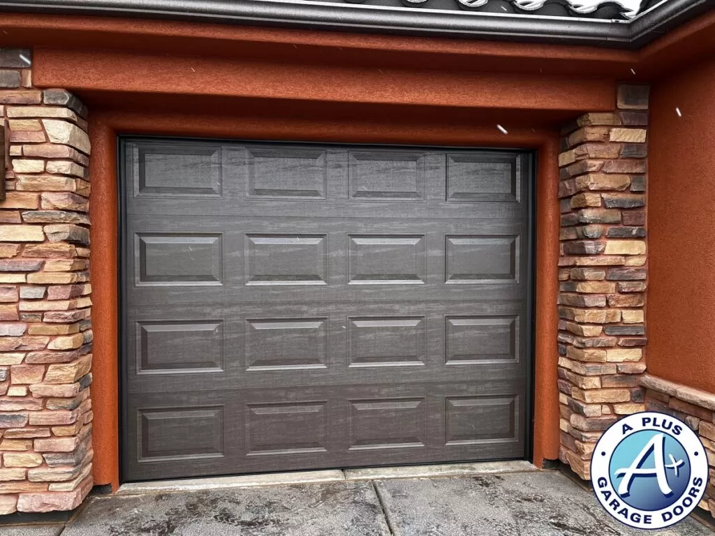Dark brown insulated Amarr garage door installation in Ivins, Utah